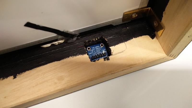 Light sensor mounted in picture frame