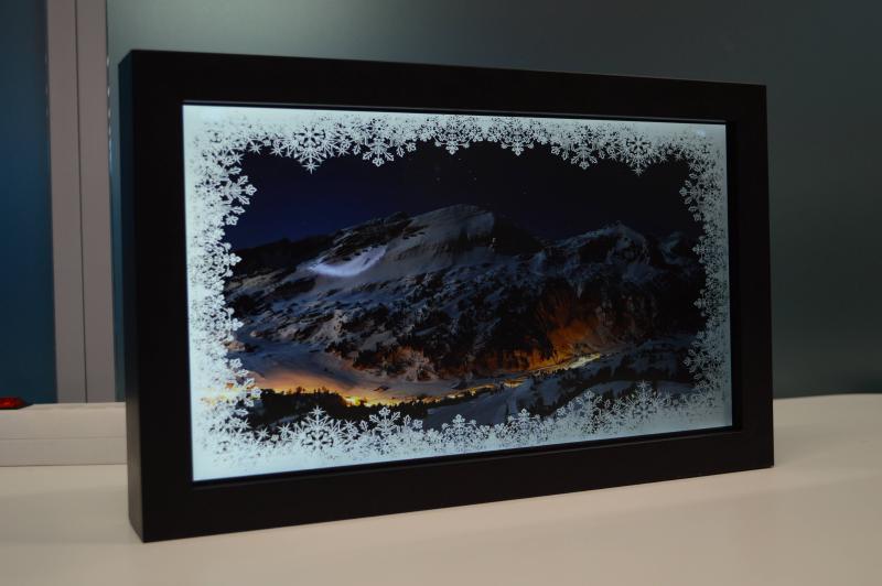 Picture frame displaying photo with snowflake border pattern