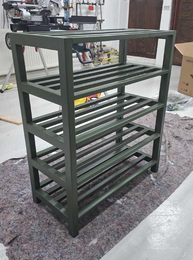 Three coats of green paint applied to shoe rack