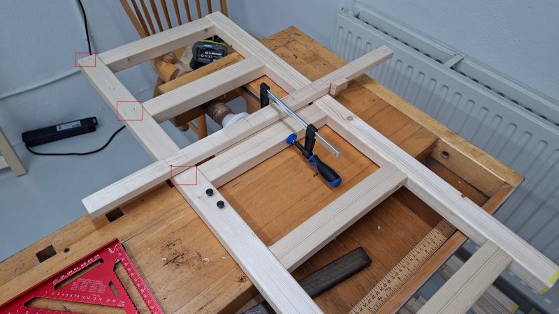 Jig clamped onto one side of shoe rack with positioning pins