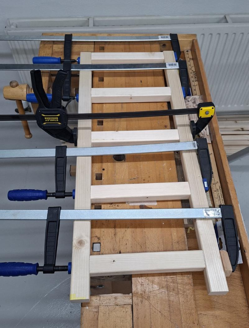 Shoe rack sides clamped together and curing